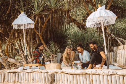 Picnic set-up under white umbrellas in the Bubble Garden at Bubble Hotel, Nyang Nyang Beach