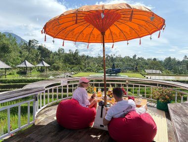Picnic under a red umbrella overlooking the Jatiluwih rice terraces